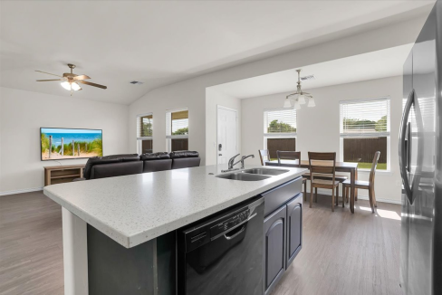 Spacious open-concept kitchen, dining area, and living room in fully furnished Altus family crashpad rental at 1713 Sommerset Pl.