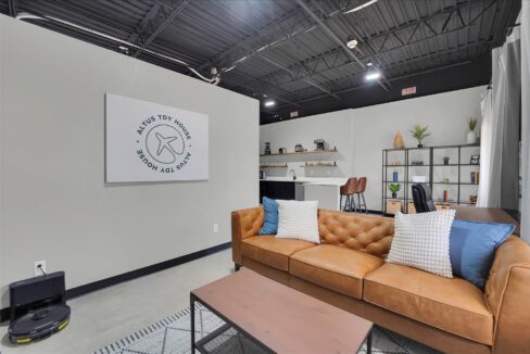 Spacious living room with modern furniture and natural light in furnished 1-bedroom loft crashpad in Altus OK, ideal temporary military housing near Altus Air Force Base